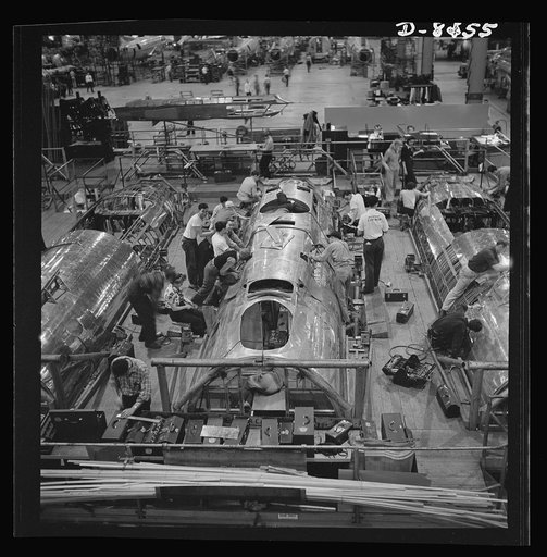 Production. B-17 heavy bomber. Fast, expert workers at the Boeing plant in Seattle apply outer "skins" to fuselage sections for new B-17F (Flying Fortress) bombers, while assembly and fitting operations go forward in the interiors. The Flying Fortress has performed with great credit in the South Pac