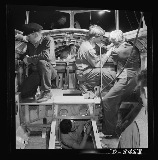 Production. B-17 heavy bomber. A skilled team of men and women workers at the Boeing plant in Seattle complete assembly and fitting operations on the interior of a fuselage section for a new B-17F (Flying Fortress) bomber. About half of the workers at the Boeing plant are women. The Flying Fortress 