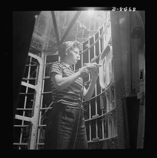 Production. B-17 heavy bomber. A woman worker at the Boeing plant in Seattle helps to complete a fuselage framework for a new B-17F (Flying Fortress) bomber. About half of the workers in this plant are women. The Flying Fortress has performed with great credit in the South Pacific over Germany and e