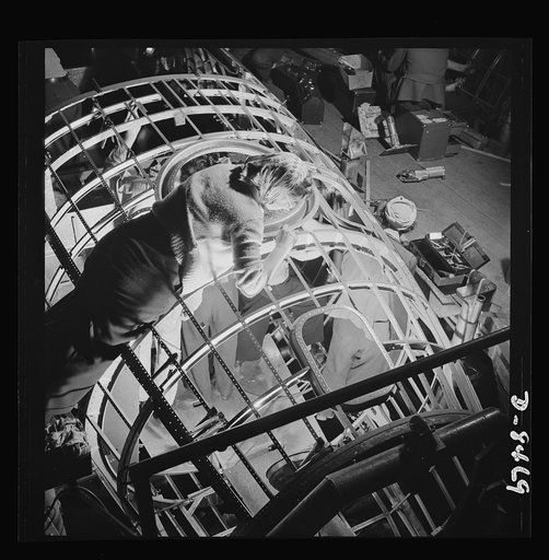 Production. B-17 heavy bomber. A woman worker at the Boeing plant in Seattle helps to complete a fuselage framework for a new B-17F (Flying Fortress) bomber. About half of the workers in this plant are women. The Flying Fortress has performed with great credit in the South Pacific over Germany and e