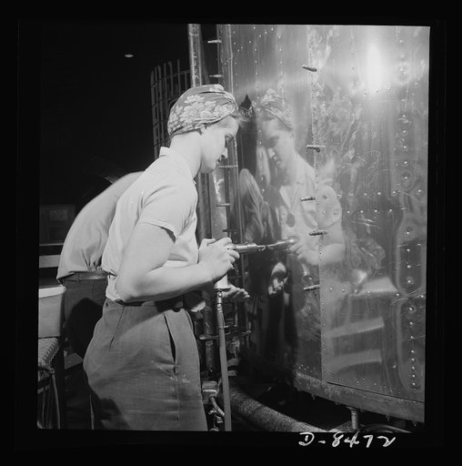 Production. B-17 heavy bomber. A woman riveter at the Boeing plant in Seattle attaches a sheet of the gleaming outer covering of a fuselage section for a new B-17F (Flying Fortress) bomber. The Flying Fortress has performed with great credit in the South Pacific, over Germany and elsewhere. It is a 