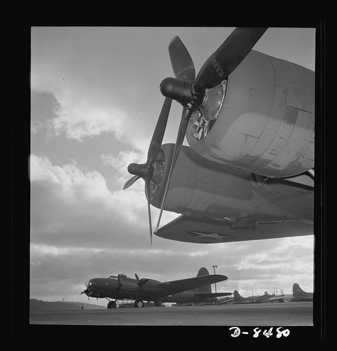 Production. B-17 heavy bomber. Two of the four mighty engines of a new B-17F (Flying Fortress) bomber loom up against a background of completed planes as another warship of the air awaits it flight tests at Boeing's Seattle plant. The Flying Fortress has performed with great credit in the South Paci