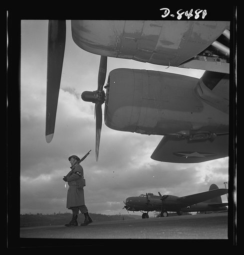 Production. B-17 heavy bomber. An Army sentry guards new B-17F (Flying Fortress) bombers at the airfield of Boeing's Seattle plant. The ship will be delivered to the Army and the Navy after they have successfully undergone flight tests. The Flying Fortress has performed with great credit in the Sout