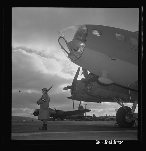 Production. B-17 heavy bomber. An Army sentry guards new B-17F (Flying Fortress) bombers at the airfield of Boeing's Seattle plant. The ship will be delivered to the Army and the Navy after they have successfully undergone flight tests. The Flying Fortress has performed with great credit in the Sout
