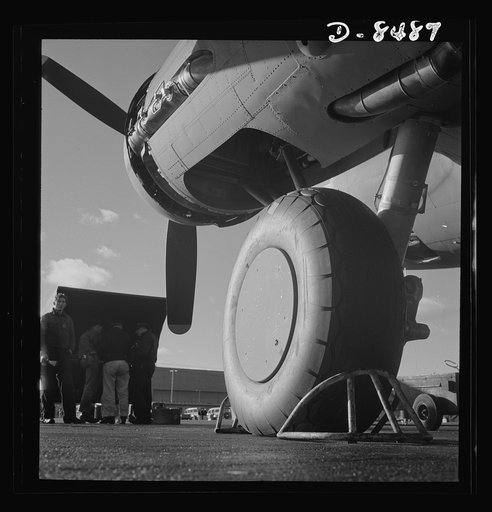 Production. B-17 heavy bomber. One of the huge landing wheels of a new B-17F (Flying Fortress) bomber ready for flight tests at the airfield of Boeing's Seattle plant. The Flying Fortress has performed with great credit in the South Pacific, over Germany and elsewhere. It is a four-engine heavy bomb