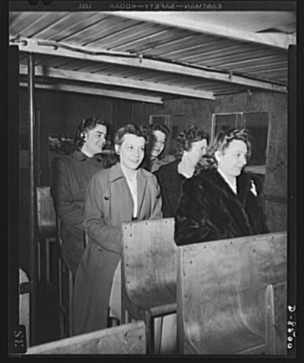 War wagon trailer. It's better than standing! Government girls accustomed to crowded buses in the nation's capitol try out the "stand-sit" seat--a space saving feature of the new war wagon trailer
