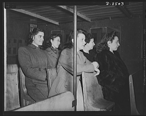 War wagon trailer. It's better than standing! Government girls accustomed to crowded buses in the nation's capitol try out the "stand-sit" seat--a space saving feature of the new war wagon trailer
