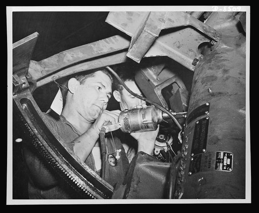 Making ready for the intricate wiring of a ship's gun is shown by Andrew S. Horn, a first class machinist from Ohio. Following him up with the wiring operation is R.V. Presby, a first-class electrician, from Tennessee, Ordnance Shop. Navy yard, Pearl Harbor