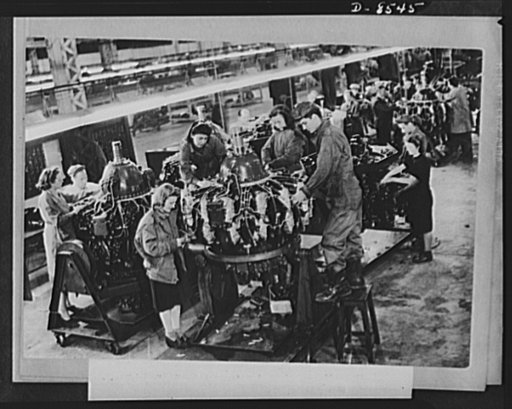 One year of reciprocal aid. British girls and American technicians work together at a U.S. Army Air Force maintenance department. This is only one of dozens of services rendered our forces by British civilians. The British government pays $240,000 a week in wages to civilian workers in the direct em