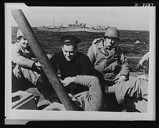 One year of reciprocal aid. British sailors and U.S. Rangers share a joke as well as ships. More than thirty troops, transports of the British Merchant Navy, were in the first convoy that swept through the Mediterranean in the invasion of North Africa, in company with American forces under escort of