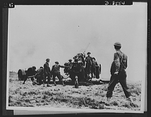 One year of reciprocal aid. Practically everything needed by our forces in Britain is supplied by the British government under reciprocal lend-lease. American soldiers here use British made guns and ammunition in training to defend U.S. bomber- fighter and aircraft repair bases in Great Britain. The