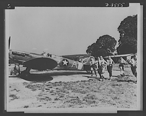 One year of reciprocal aid. Pilots of the U.S. Spitfire squadron in Great Britain are seen running to their planes. This aircraft with full complement of British fighter craft is one of hundreds turned over to the Americans by British government under reciprocal aid. Several of our fighter squadrons