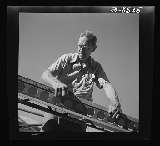 Conversion. Rowing shells to life rafts. At his old job making rowing shells for varsity crews, this veteran craftsman now helps produce plywood life rafts for Navy ships. Here he is shown at work on the frame of a rowing shell