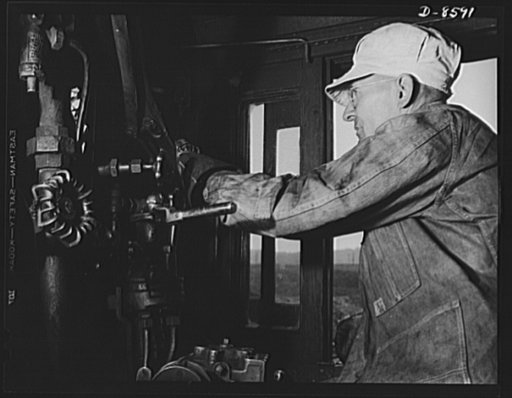 Tennessee Valley Authority. Railroad crews at Watts Bar Dam. A combination of long mechanical experience, practical railroad training and common sense is required for the job of running one of the big "hogs," or locomotives. This engineer handles a train which hauls materials for the building of TVA
