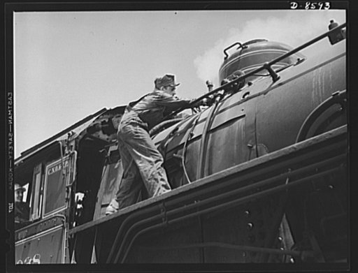 Tennessee Valley Authority. Railroad crews at Watts Bar Dam. Clearing the sand line is one of the chores that fall to the "tallow pot," or fireman, of a railway locomotive. In addition to jobs like this, the "tallow pot" serves up an average of eight to ten tons of coal each eight hour day to the bi
