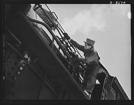 Tennessee Valley Authority. Railroad crews at Watts Bar Dam. Clearing the sand line is one of the chores that fall to the "tallow pot," or fireman, of a railway locomotive. In addition to jobs like this, the "tallow pot" serves up an average of eight to ten tons of coal each eight hour day to the bi