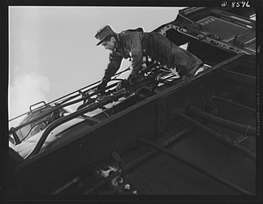 Tennessee Valley Authority. Railroad crews at Watts Bar Dam. Clearing the sand line is one of the chores that fall to the "tallow pot," or firemen of a  railway locomotive. In addition jobs like this, the "tallow pot" serves up an average of eight to ten tons of coal each eight hour day to the big "