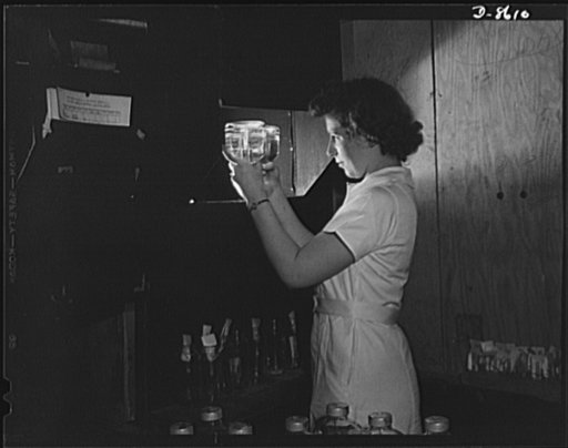 Production. Blood transfusion bottles. Transfusion bottles containing intravenous solution, are given another inspection after being taken from the sterilizer. Margie Easton is one of the many women workers at Baxter Laboratories, Glenview, Illinois, where plasma containers are prepared for blood le
