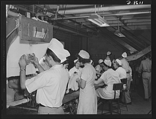 Production. Blood transfusion bottles. Laboratories assembly line at Baxter Laboratories, Glenview, Illinois, showing inspection, labeling and wrapping of blood transfusion bottles containing intravenous solution