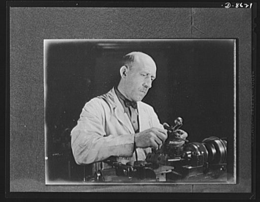 Production. Blood transfusion bottles. Valves and needles for blood transfusion bottles are turned out by O. Trumbull Scalbon, who with his father manufactures parts under subcontract to Baxter Laboratories Inc., Glenview, Illinois. Here he checks the size of thread and concentricity of a tube