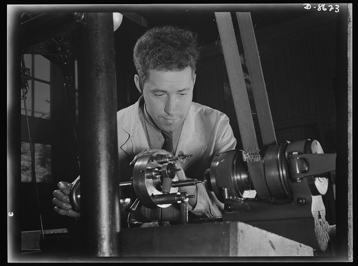 Production. Blood transfusion bottles. In a small plant working under subcontract, John Kerr operates a turret lathe for tapping and drilling valves for blood transfusion bottles prepared by the prime contractor, Baxter Laboratories Inc., Glenview, Illinois