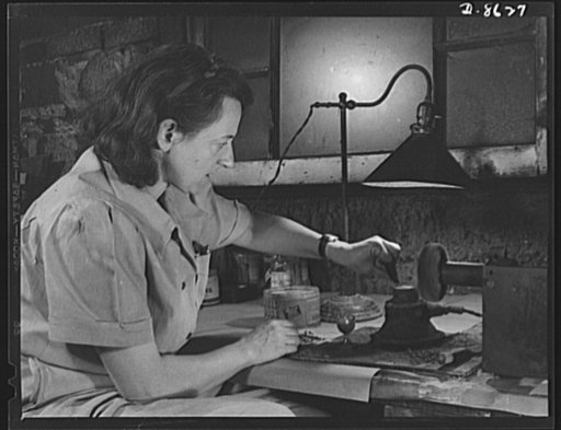 Production. Blood transfusion bottles. Formerly a sculptress and designer of tiles, Dorothy Cole converted her basement into a workshop of tin plate needles for valves for blood transfusion bottles prepared by Baxter Laboratories, Glenview, Illinois, where she lives. She turns in her profits to war 