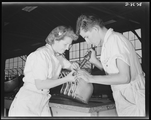 Naval air base. Corpus Christi, Texas. Learning to "keep 'em flying," trainees at the Corpus Christi, Texas naval air base, Inga Johnsen and Edwin McLelland, National Youth Administration (NYA), prepare for civil service jobs at the base. They are shown here during their eight weeks apprenticeship a