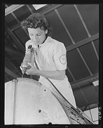 Naval air base Corpus Christi, Texas. A rivet is her fighting weapon, Oyida Beaks, daughter of a Navy lieutenant, one of many women taking National Youth Administration (NYA) training to become mechanics at the naval air base in Corpus Christi, Texas. After eight weeks' apprenticeship she will be qu