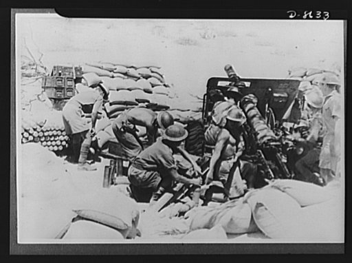 India in the war. Indian soldiers in action before the capture of Keren. This gun hurled approximately 24,000 shells a day. Note the shadow of camouflage on the field gun