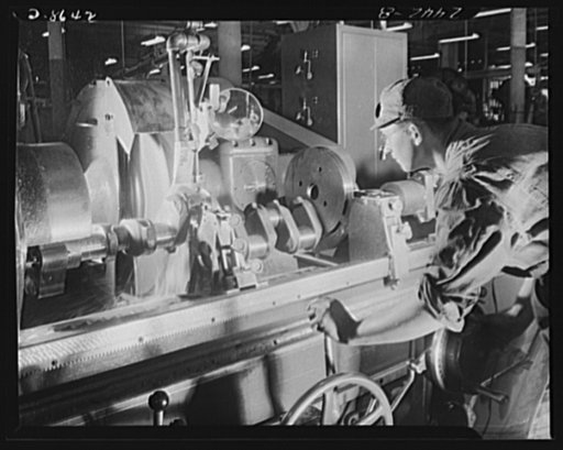Conversion. Farm implements to cargo winches. Grinding a crankshaft for a farm tractor engine in a large Midwestern implement plant before the machine was converted to the grinding of axles for marine cargo winches