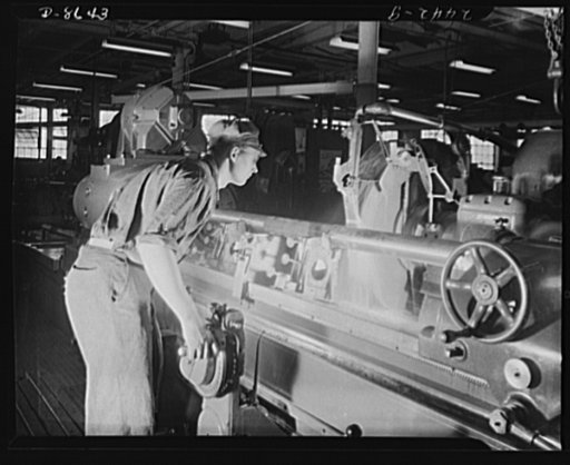 Conversion. Farm implements to cargo winches. Grinding an axle for a marine cargo winch in the converted Midwestern plant of a farm implement manufacturer. This machine was formerly used to grind crankshafts for farm tractors
