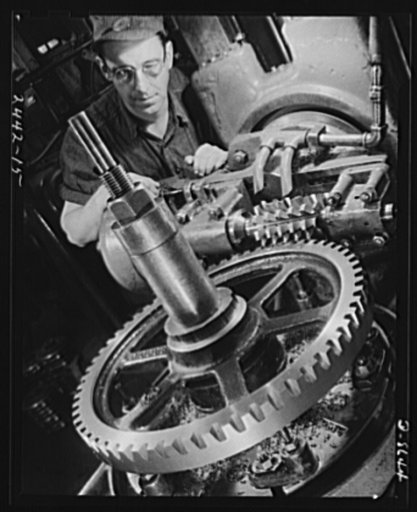 Conversion. Farm implements to cargo winches. Hobbing a gear for a cargo winch for the Maritime Commission. This machine in the converted Midwestern plant of a farm implement manufacturer was used to produce gears for tractors and other farm equipment