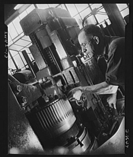 Conversion. Farm implements to cargo winches. Hobbing five bull gears simultaneously for a plow tractor prior to the conversion of a Midwestern farm implement manufacturer. The machine has since been adapted to cutting gears for cargo winches for the Maritime Commission