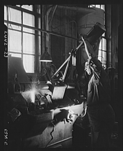 Conversion. Farm implements to gun parts. A grinding operation is performed on a Bofors gun slide in a converted Midwestern farm implement plant which is also making marine steam cargo winches for the Maritime Commission