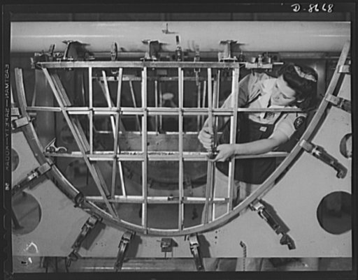 Production. B-24 bombers and C-87 transports. Helen Bray, who left school to become a mechanic at a Western aircraft plant, is making an emplanage section on a new consolidated transport. This new ship, adapted from the B-24 bomber, is known as the C-87, carries one of the greatest human and cargo l