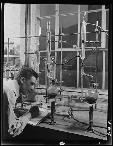 Science and research. Studies of non-coking coals. William S. Landers, assistant chemical engineer at the Golden, Colorado field station of the U.S. Bureau of Mines, takes a reading from moisture distillation apparatus which determines the water content of coal. Most western coal is high in oxygen a