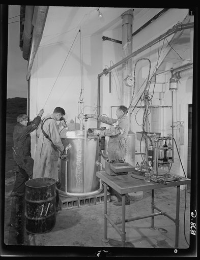 Science and research. Studies of non-coking coals. Research workers at the Golden, Colorado field station of the U.S. Bureau of Mines at a fifty-pound coke oven, which is used to determine if an unknown coal has coking properties. Coal is tested at various temperature levels to determine its adaptab