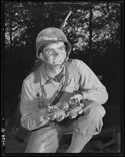 Fort Belvoir, Virginia. Grenade throwers. Ready to make a shipment of pineapples to Hitler, Hirohito & Co. An infantryman at Fort Belvoir, Virginia, holds a double handful of deadly grenades that may one day blast open a road to Berlin or Tokyo