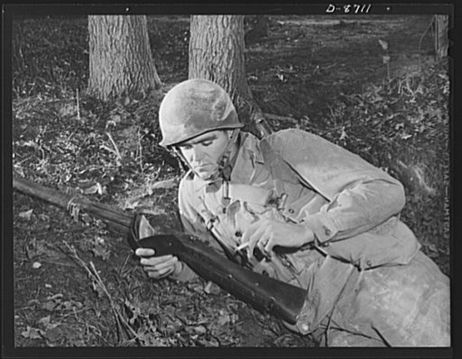 Fort Belvoir, Virginia. Negro grenade throwers. A soldier and his memories. An infantryman in training at Fort Belvoir, Virginia, looks over his cherished collection of pictures from home as he enjoys a cigarette during a well-earned rest period
