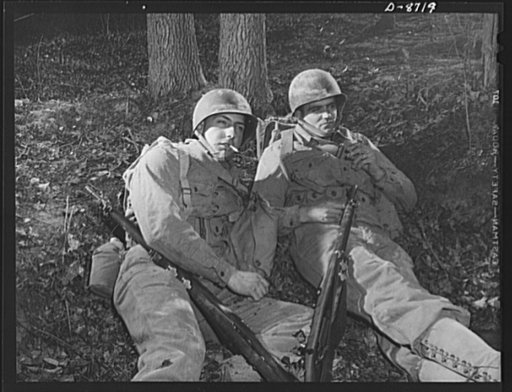 Fort Belvoir, Virginia. Training sidelights. "Grabbing a couple of quick smokes" during a well-earned rest period in training exercises at Fort Belvoir, Virginia. Privates Fred Heindereich and Harry Fleming enjoy cigarettes while waiting for the next orders