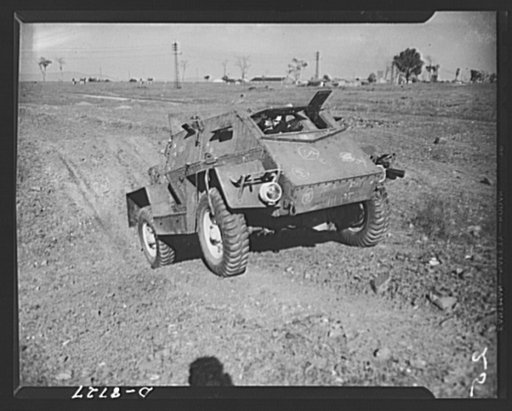 Combat car in India. A newly completed armored combat car going through a rigid final test somewhere in India. The armored plate is put on the chasis in India. Lend-lease materials and equipment play a vital part in the manufacture of these cars