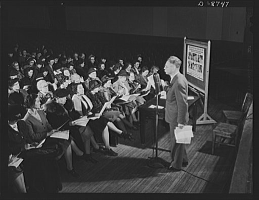 Preparation for point rationing. Norman J. Nelson, principal of Wilson Senior High School, Washington, D.C., instructs teachers on methods of registering civilians for war ration book two, a few days before registration period begins