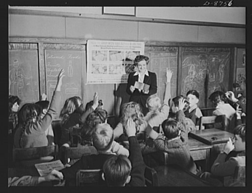 Preparation for point rationing. Facts the younger generation of marketers should know are taught in the Murch Elementary School, Washington, D.C. Catherine M. Rooney, 6th grade teacher, instructs her alert pupils on the way and how of war ration book two