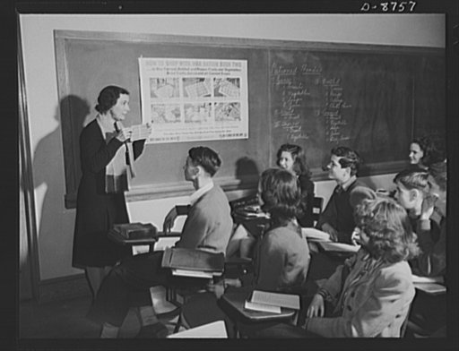 Preparation for point rationing. Miss Julie Gill, teacher at the Wilson Senior High School, Washington, D.C., acquaints her students with the need for point rationing and explains how war ration book two is to be used in marketing