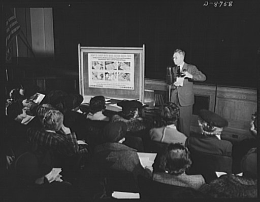 Preparation for point rationing. Norman J. Nelson, principal of Wilson Senior High School, Washington, D.C., instructs teachers in all schools in Area 13 on methods of registering civilians for war ration book two