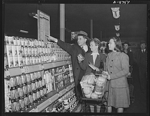 Preparation for point rationing. With an official as their guide, woman shopper and daughter get their first experience in using war ration book two in purchasing processed foods. Harold B. Rowe, director of Office of Price Administration's (OPA) Food Rationing Division, indicates the point values o