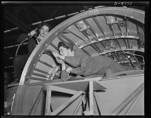 Production. B-24E (Liberator) bombers at Willow Run. A girl team working on a center wing section of a B-24E (Liberator) bomber in Ford's big Willow Run plant. The Liberator is capable of operation at high altitudes and over great ranges on precision bombing missions. It has proved itself an excelle