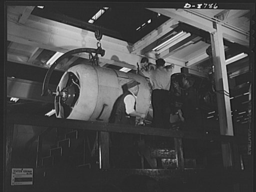 Production. B-24E (Liberator) bombers at Willow Run. Installing one of the four engines of a new B-24E (Liberator) bomber on one of the assembly lines of Ford's big Willow Run plant. The Liberator is capable of operation at high altitudes and over great ranges on precision bombing missions. It has p