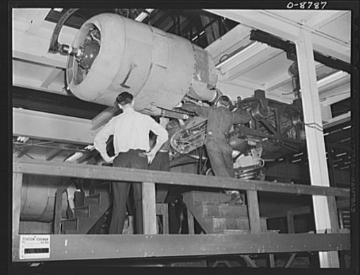 Production. B-24E (Liberator) bombers at Willow Run. Installing one of the four engines of a new B-24E (Liberator) bomber on one of the assembly lines of Ford's big Willow Run plant. The Liberator is capable of operation at high altitudes and over great ranges on precision bombing missions. It has p