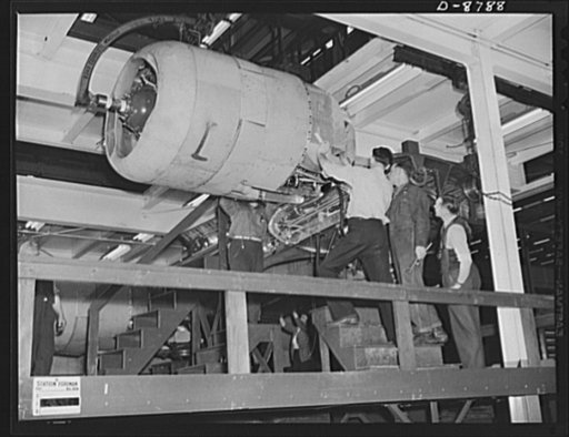 Production. B-24E (Liberator) bombers at Willow Run. Installing one of the four engines of a new B-24E (Liberator) bomber on one of the assembly lines of Ford's big Willow Run plant. The Liberator is capable of operation at high altitudes and over great ranges on precision bombing missions. It has p
